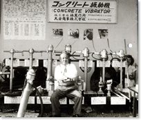 Monochrome photograph of multiple concrete vibrators lined up
